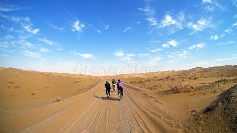 Mountain bikers riding the bike in a desert road