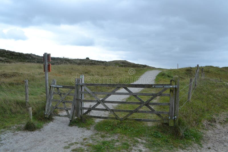 Landscape with gate of a shell footpath in the Dutch dunes stock images