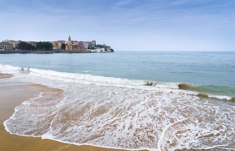 Landscape of Gijon beach in Asturias with the Church area in the background. Landscape of Gijon beach in Asturias with the Church area in the background.