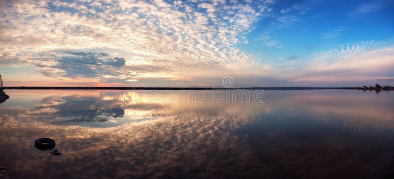Landscape with lake reflection clouds. Beautiful summer sunset