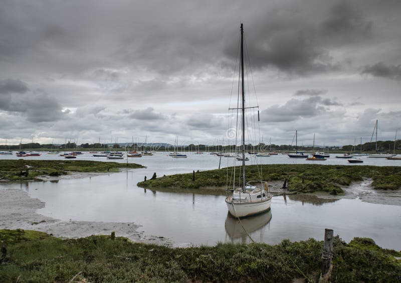 Landscape of moody evening sky over low tide marine