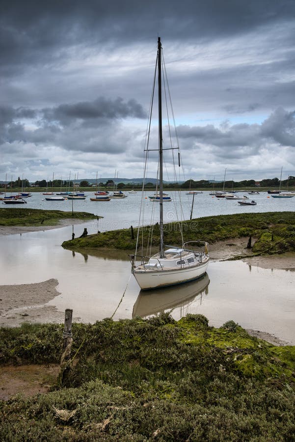 Landscape of moody evening sky over low tide marine