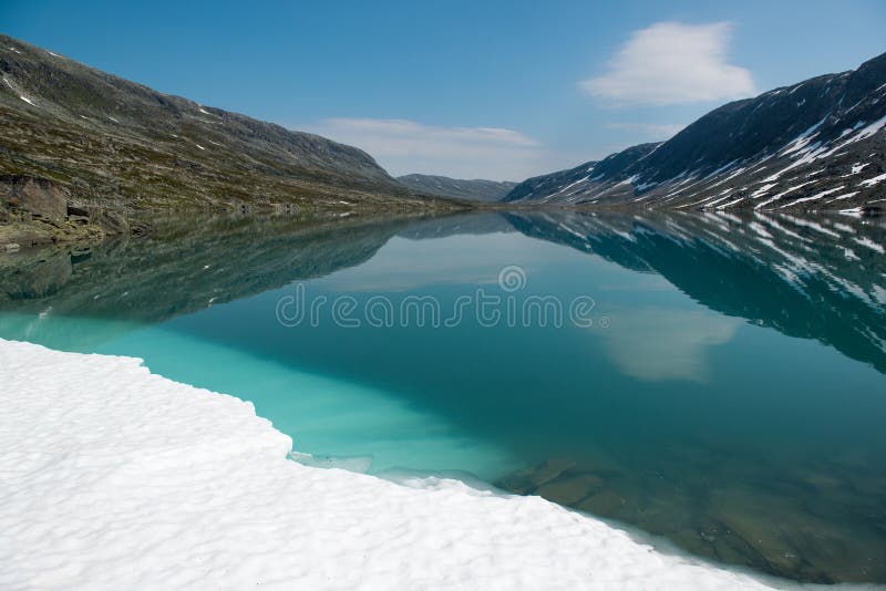 Landscape with mountain lake and snow, Norway stock images Landscape with mountain lake and snow, Norway stock images