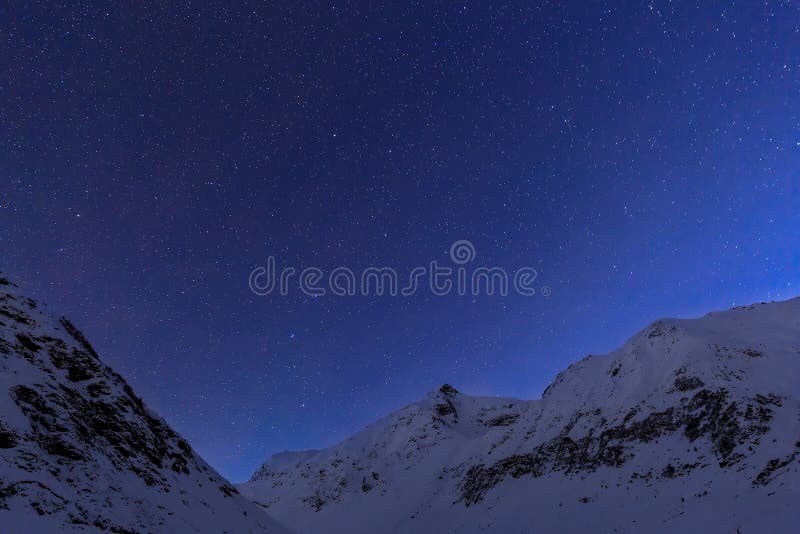 Landscape with mountains and blue sky in winter night in Romania