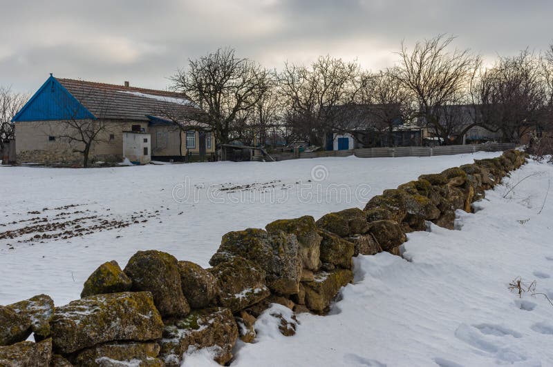 Landscape with peasant homestead surrounded with small stone wall in Skelky village, Zaporizhia Oblast, Ukraine