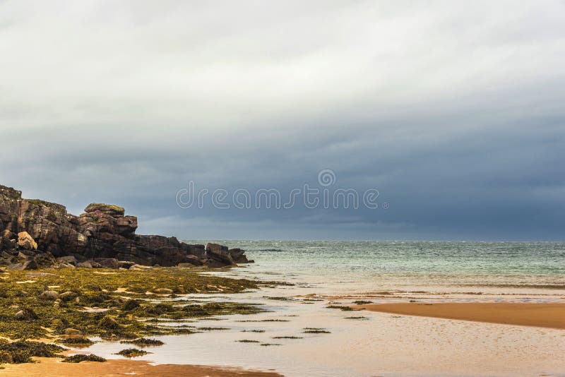 Landscape on the road to Red Point beach, Wester Ross. Rural views in wester ross with the red point beach and a cloudy sky in the background royalty free stock photo Landscape on the road to Red Point beach, Wester Ross. Rural views in wester ross with the red point beach and a cloudy sky in the background royalty free stock photo