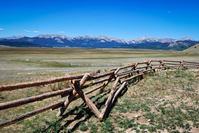 Landscape of Rocky Mountains with log fence