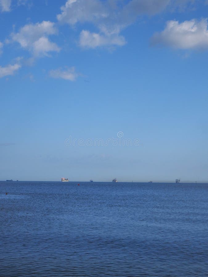 Blue sea horizon line with ships stock photography Blue sea horizon line with ships stock photography