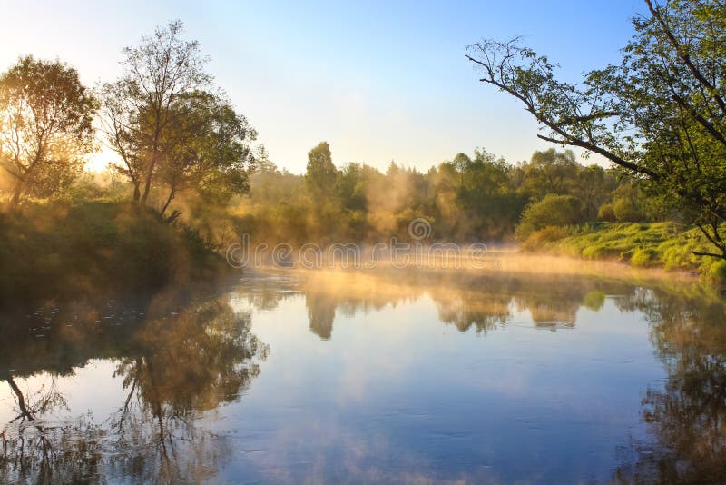 Landscape with sunrise over the river and fog