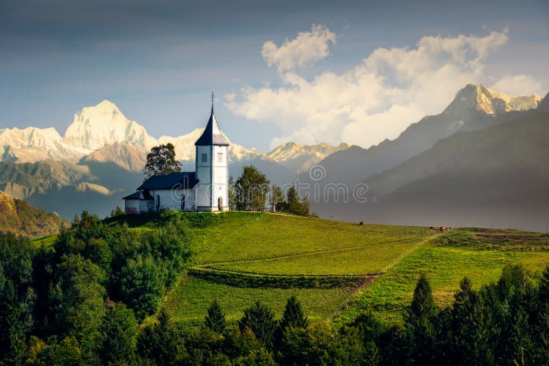 Landscape view of Jamnik church and generic mountains - composite image, Slovenia