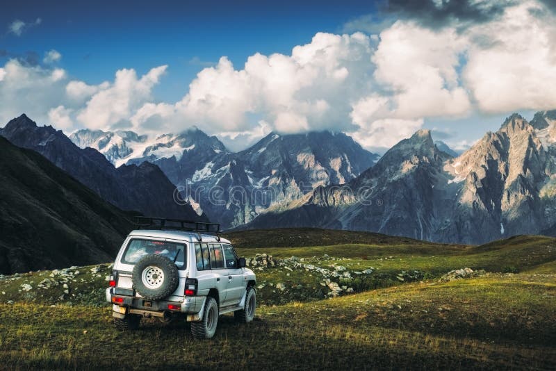 Landscape view of mountain range and offroad car in the meadow, Svaneti national park, Georgia