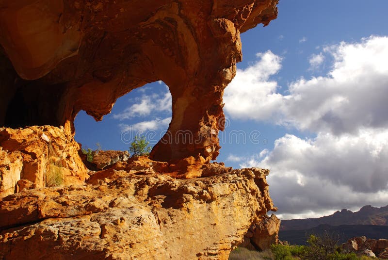 Landscape - yellow -red rocky arc against blue sky