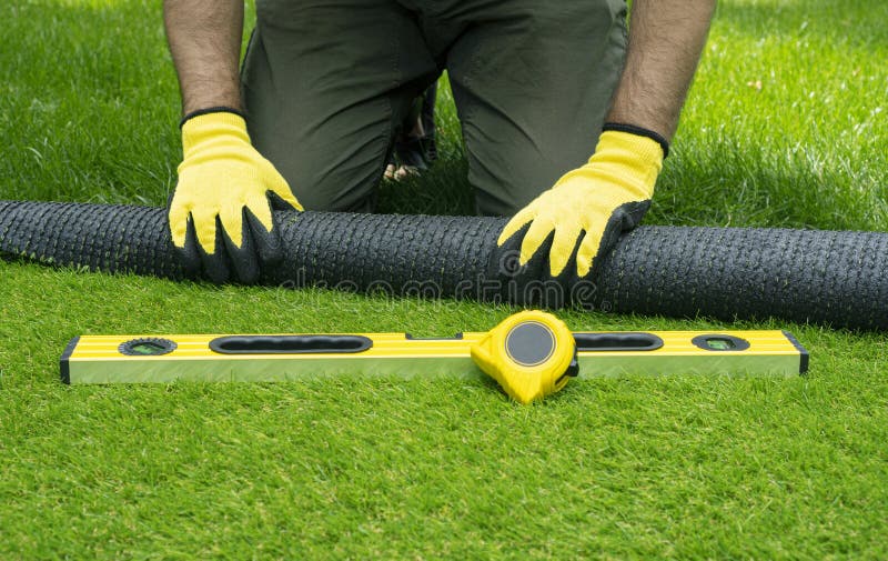 Landscaping of the yard with artificial turf. royalty free stock image