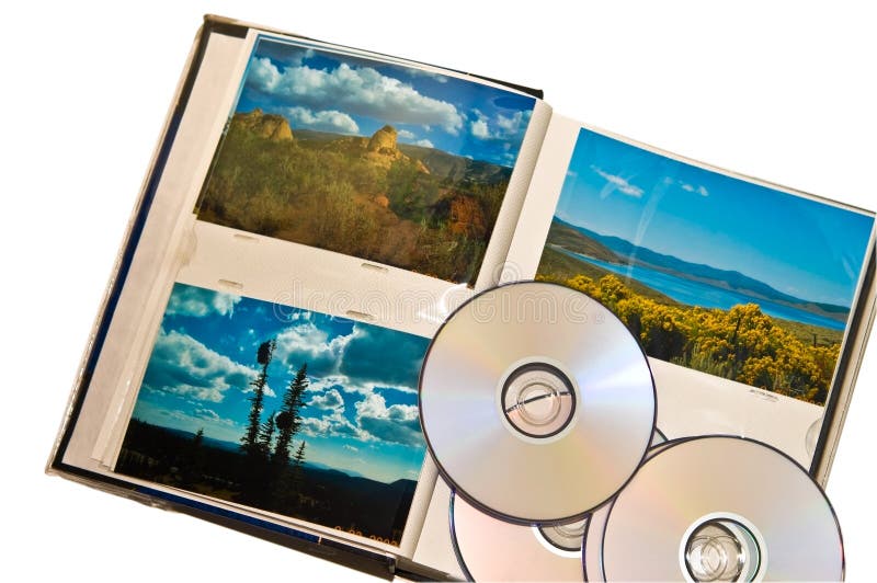 A group of travel photos on top of a photo album with some CD's. Concept for backing up your images onto a CD or DVD for safety or future use. A group of travel photos on top of a photo album with some CD's. Concept for backing up your images onto a CD or DVD for safety or future use.