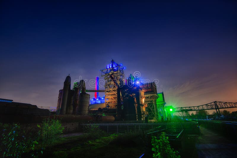 Landschaftspark Duisburg-Nord. Nightshot at the Landschaftspark (LaPaDu), this old indutrial area is now used as a park and is illuminated with a colourfull stock photography Landschaftspark Duisburg-Nord. Nightshot at the Landschaftspark (LaPaDu), this old indutrial area is now used as a park and is illuminated with a colourfull stock photography