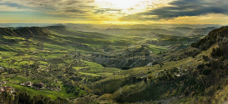 the image describes the landscape panorama at sunset from the city of enna in sicily. the image describes the landscape panorama at sunset from the city of enna in sicily