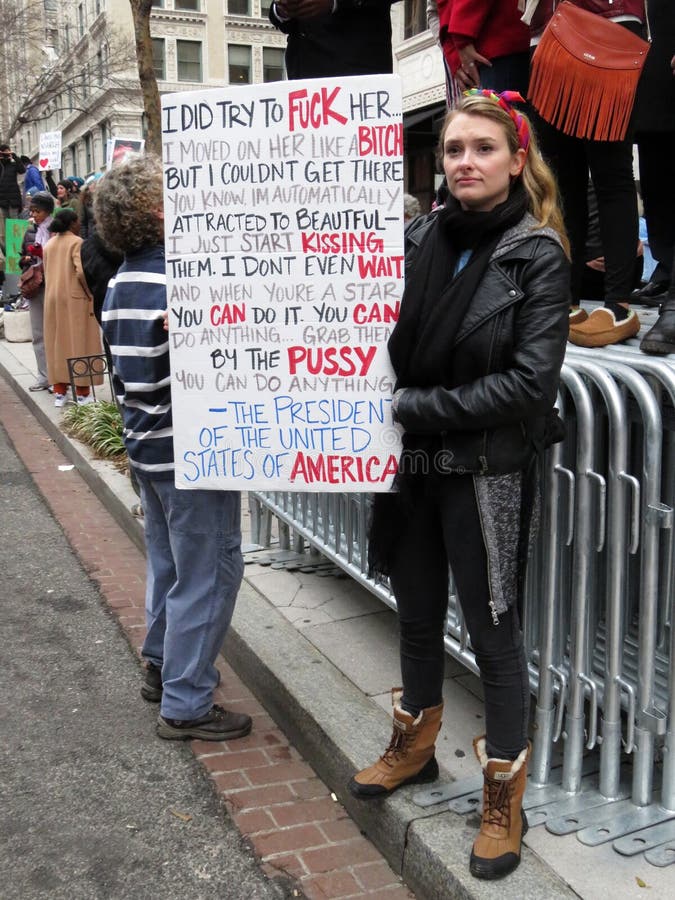 Photo of woman protester bearing a large sign with a long message at the women`s march on 1/21/17 in washington dc. Donald trump was elected president to a divided country. This march drew over 1 million people with most of them being women. Photo of woman protester bearing a large sign with a long message at the women`s march on 1/21/17 in washington dc. Donald trump was elected president to a divided country. This march drew over 1 million people with most of them being women.