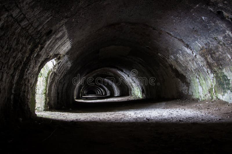 Langcliffe lime kiln in Settle, Yorkshire. Old, dark stone tunnel with arches and interesting light