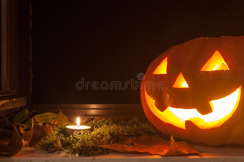 Lanterna de incandescência de Jack o em um peitoril foto de stock Lanterna de incandescência de Jack o em um peitoril foto de stock