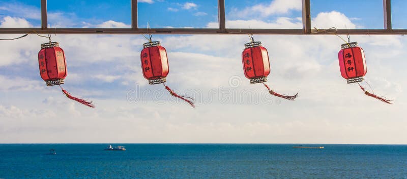 Lanternas de papel chinesas vermelhas contra um céu azul e um mar imagem de stock royalty free Lanternas de papel chinesas vermelhas contra um céu azul e um mar imagem de stock royalty free