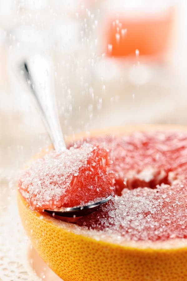 Lappa av den röda grapefrukten med socker, fruktefterrätt fotografering för bildbyråer Lappa av den röda grapefrukten med socker, fruktefterrätt fotografering för bildbyråer