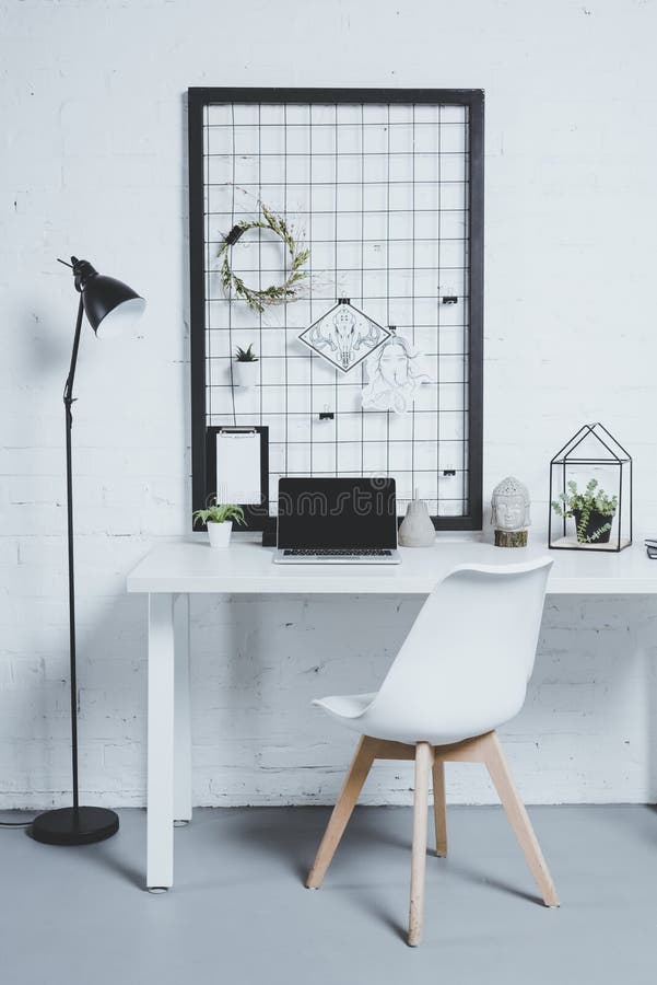 laptop with blank screen and plants on table in modern office stock image laptop with blank screen and plants on table in modern office stock image