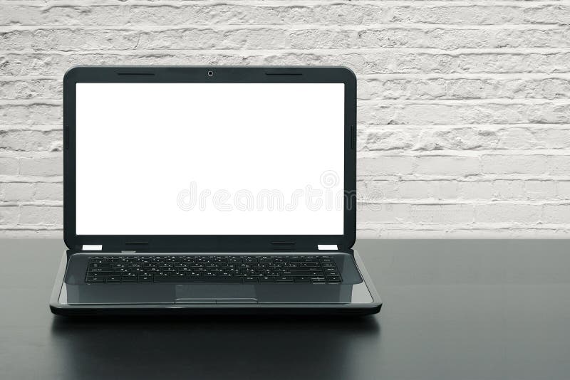 Laptop with blank screen on wooden table