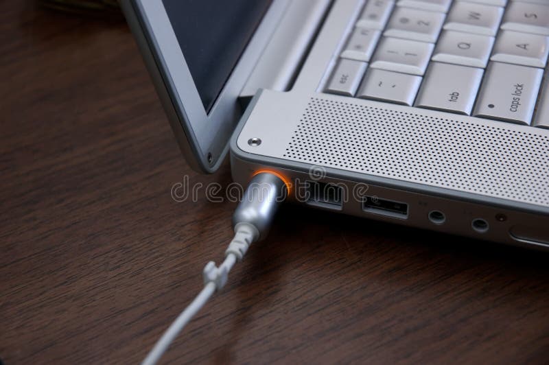 Laptop charging stock image. Image of plugged, grey, batteries 88235