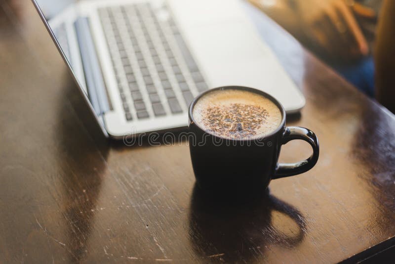 Laptop and coffee cup at his working place in Cafe royalty free stock photography Laptop and coffee cup at his working place in Cafe royalty free stock photography
