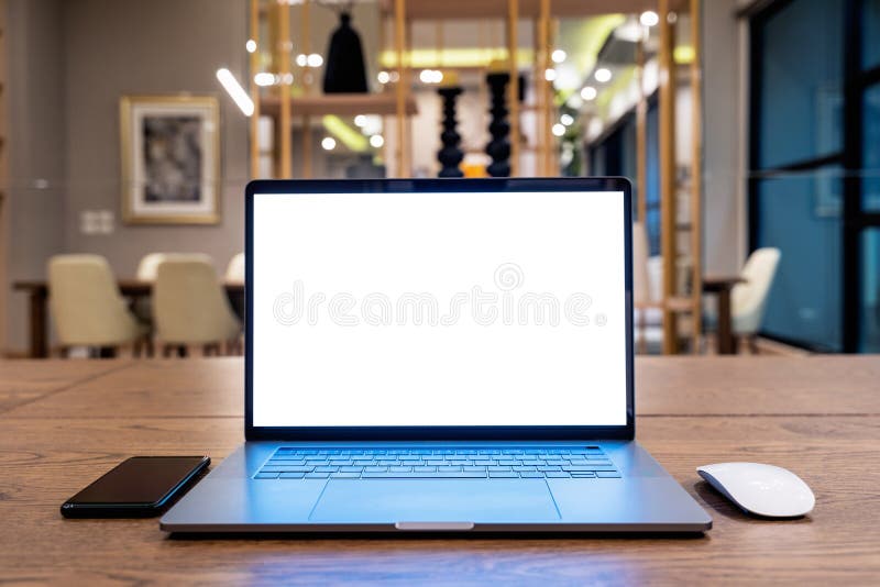 Laptop computer with blank white screen on table. Office concept royalty free stock photo