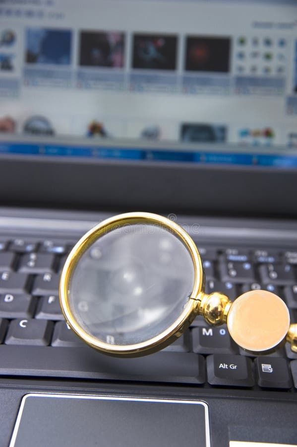 Laptop + Magnifying Glass stock photo. Image of research 10910874