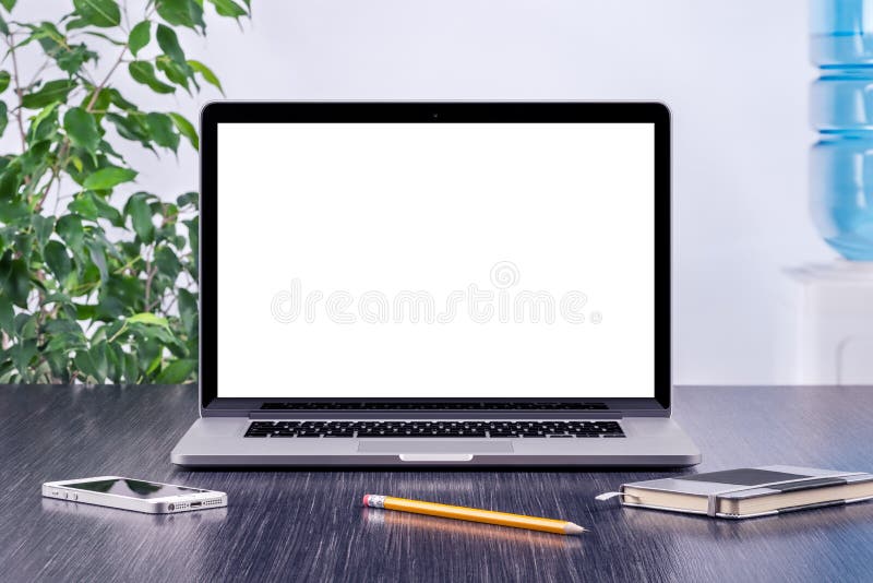 Laptop computer mockup with blank screen on office desk royalty free stock photography