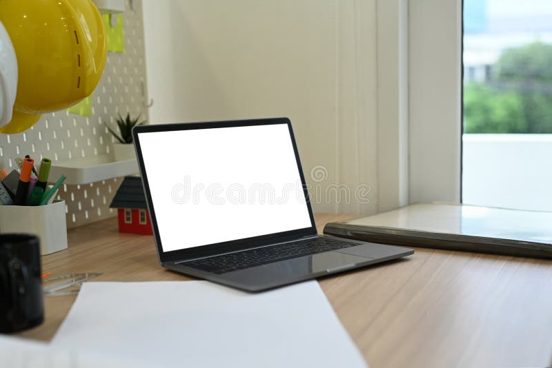 Laptop Computer, Stationery, Blueprints and Hardhat on Wooden Working