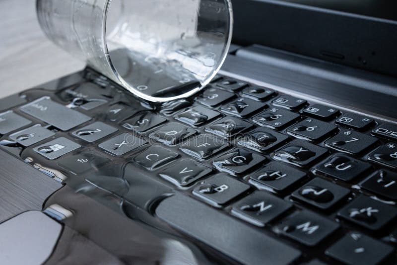 Water Being Spilled Over Laptop by Accident. Editorial Stock Photo