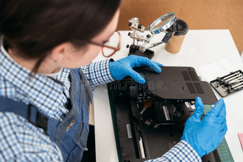 Laptop Disassembling at Electronic Repair Shop. Female Engineer