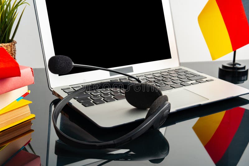 Laptop with German Flag on Working Table, Educational Concept Stock