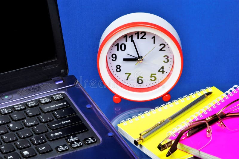 A laptop for the Manager`s work, a clock is a symbol of time, a reminder of the past and the future. Notepad, glasses, and pen fo royalty free stock photo A laptop for the Manager`s work, a clock is a symbol of time, a reminder of the past and the future. Notepad, glasses, and pen fo royalty free stock photo