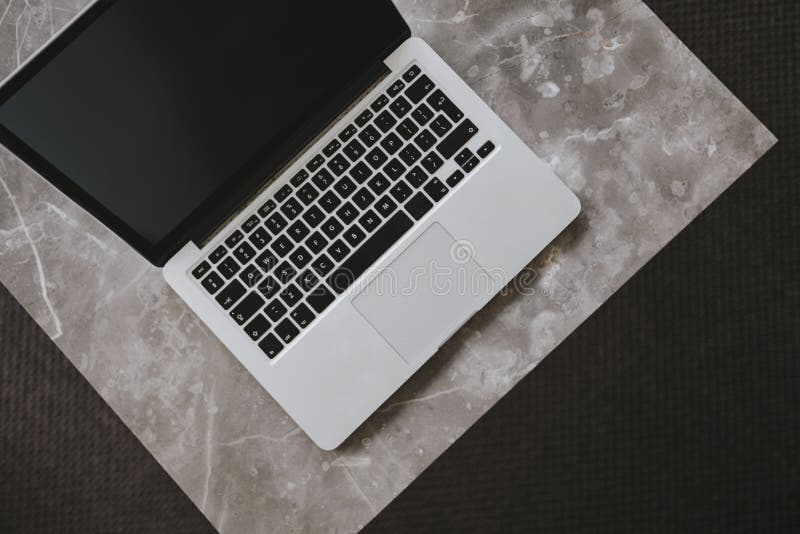 A laptop on a marble table stock photo. Image of media 130819474