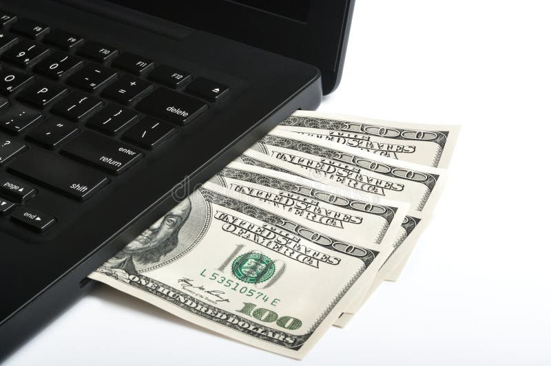 Black laptop with $100 dollar bills coming out of the optical drive slot on a white background. Black laptop with $100 dollar bills coming out of the optical drive slot on a white background.