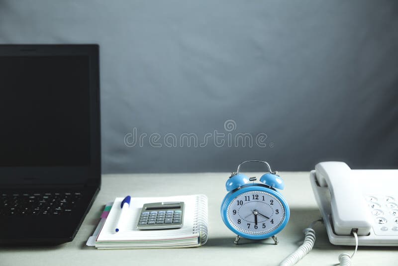 Laptop, Notepad, Alarm Clock and Office Phone. Business Concept Stock