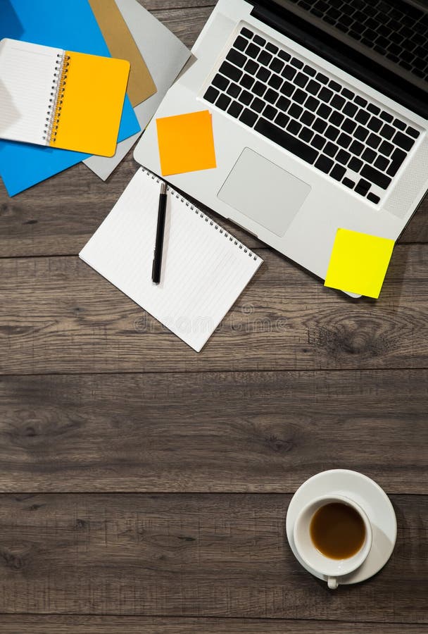 Office Desk with Laptop with Business Accessories and Cup of Tea