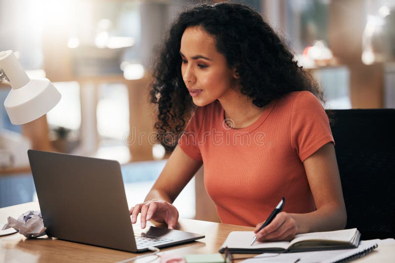 Laptop, office and business woman writing notes in office for planning, agenda and schedule in notebook. Creative agency