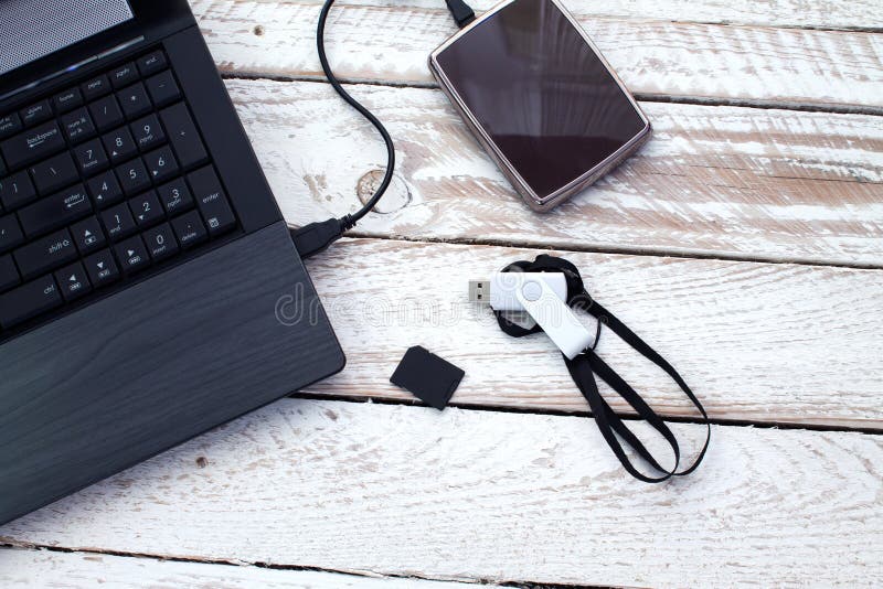 Laptop with pendrive, sd card and portable hard drive. royalty free stock images