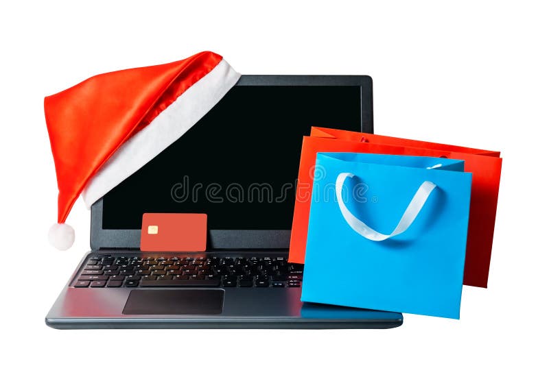 Laptop with red santa hat, credit card and shopping bags isolated stock photography Laptop with red santa hat, credit card and shopping bags isolated stock photography