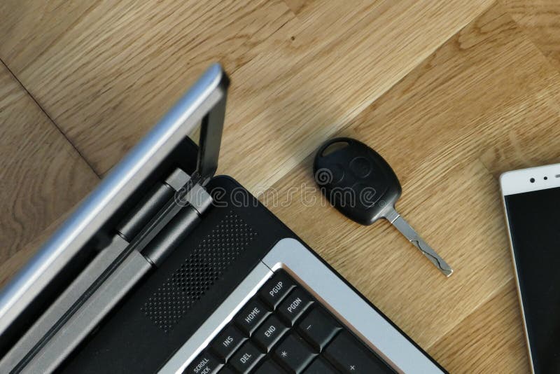 The laptop, smart phone the car key and hardwood floors royalty free stock image The laptop, smart phone the car key and hardwood floors royalty free stock image