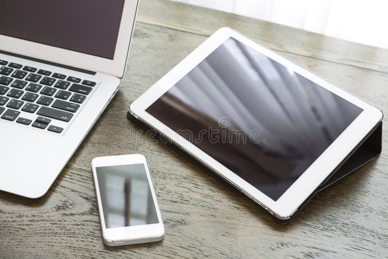 Laptop with tablet and smart phone on table