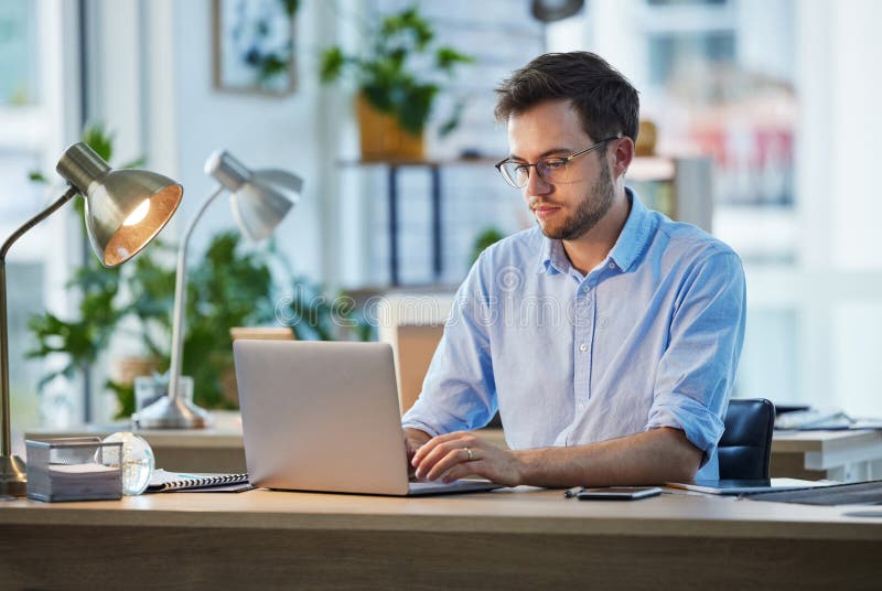 Laptop, typing and business man, IT and working on web project in office at night. Focus, computer and male professional stock photos