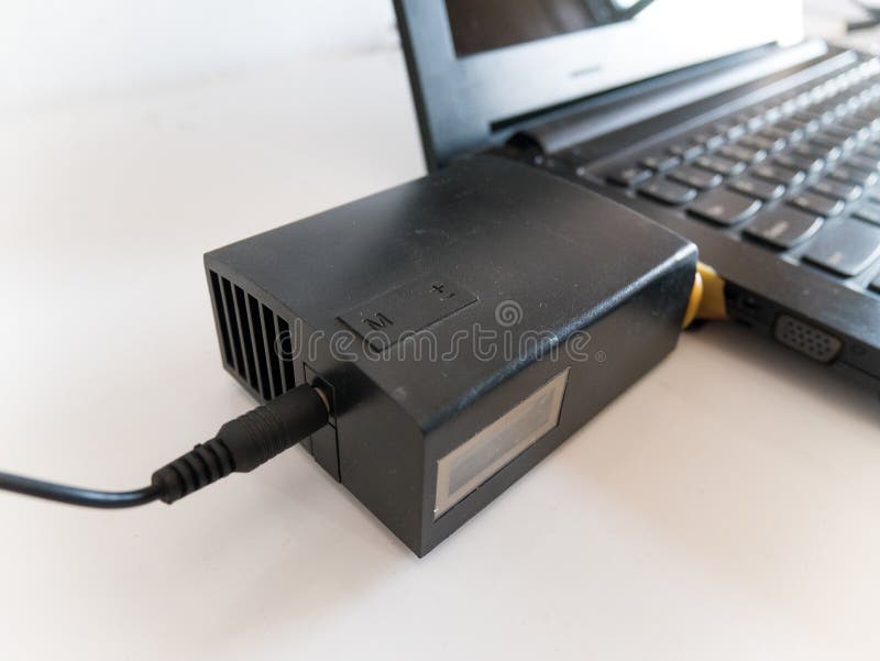 Laptop with Vacuum Cooler Attached To Laptop Air Vent Stock Photo