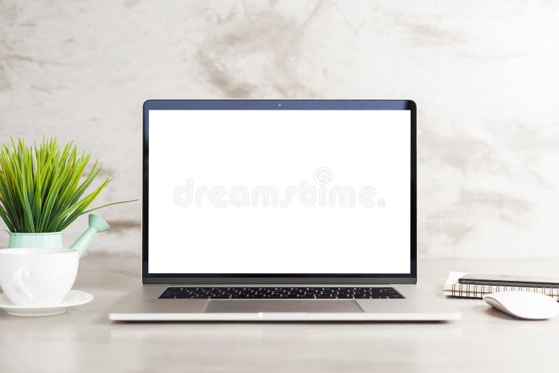 Laptop white blank screen on work table front view royalty free stock photos