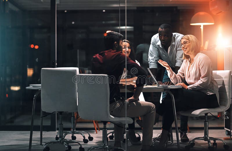 Laptop, window and business people with meeting at night for brainstorming, research or project plan. Creative team stock image